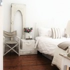 White bedroom with suitcases