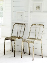 Vintage metal chairs against white wall