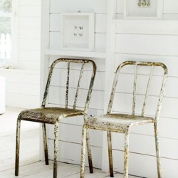 Vintage metal chairs against white wall