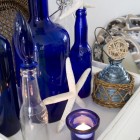 decorative display for summer with blue glass and beach accents