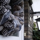 pine cones and ribbon in brown and silver Christ wreath on my front door