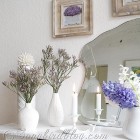 mantel decoration with purple and white flowers