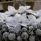 white pine cone wreath with poinsettia