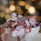 a red and white Christmas tree with craft ornaments