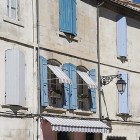 France house with blue shutters and canapes