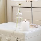 white suitcase bedside table