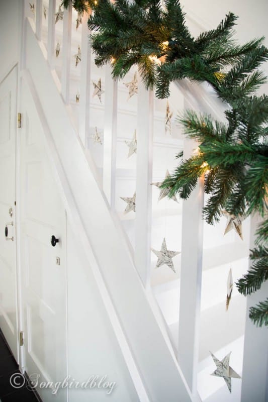 paper star garlands Christmas hallway and staircase decor