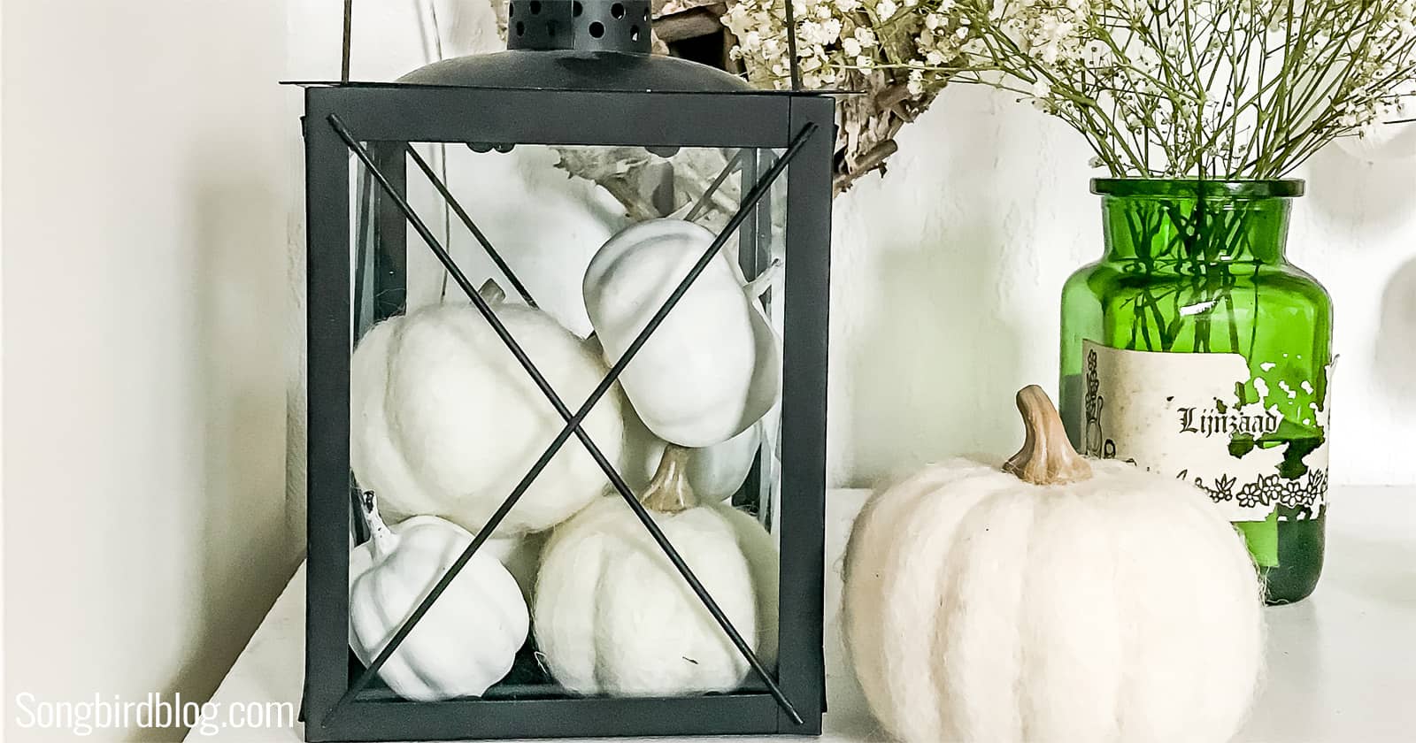 fall lantern decor with blank lantern filled with white pumpkins