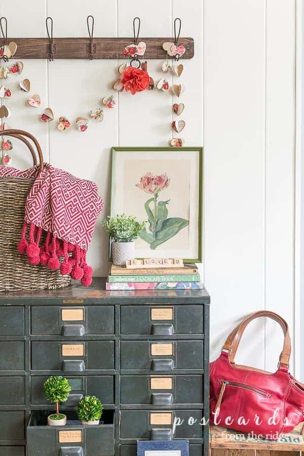 Paper heart garland over a cabinet of drawers