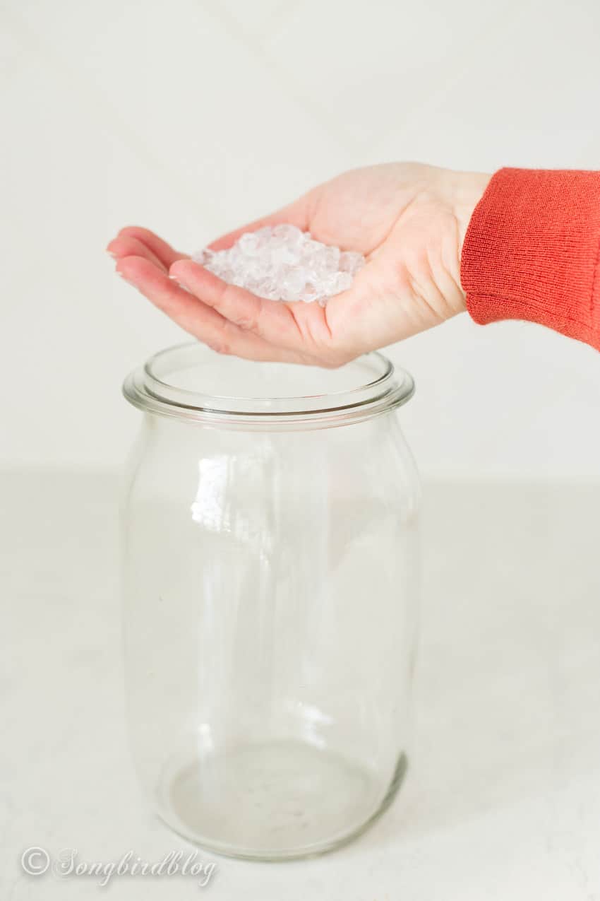 adding ice rocks vase filler to a glass vase