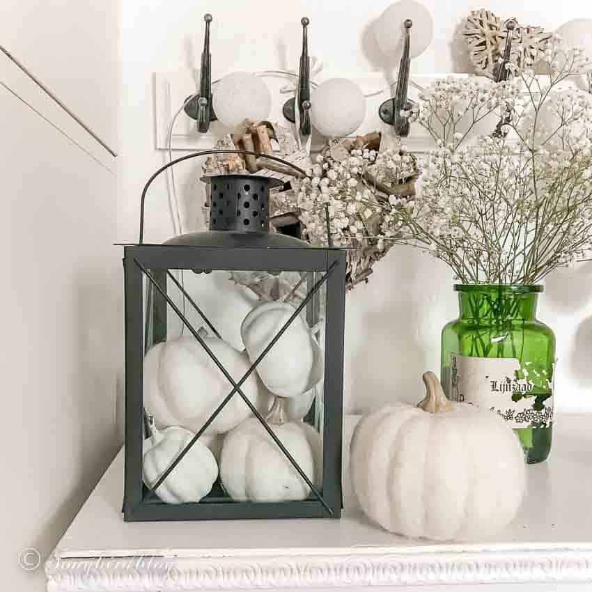 autumn decor with a lantern filled with pumpkins