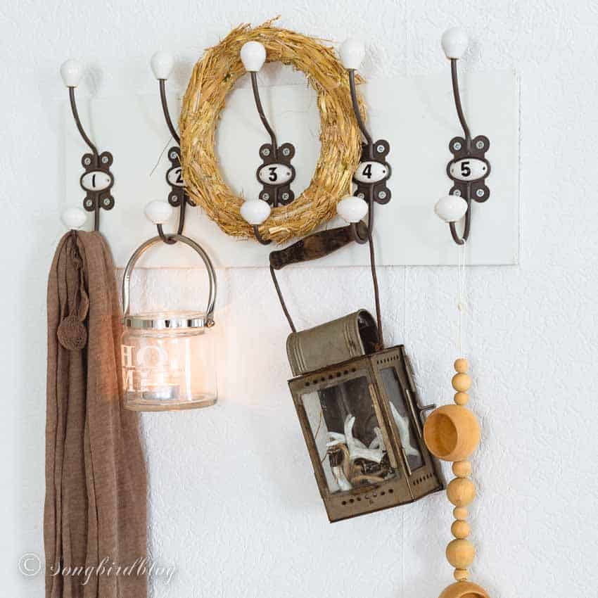 wall hooks with fall decor and lantern