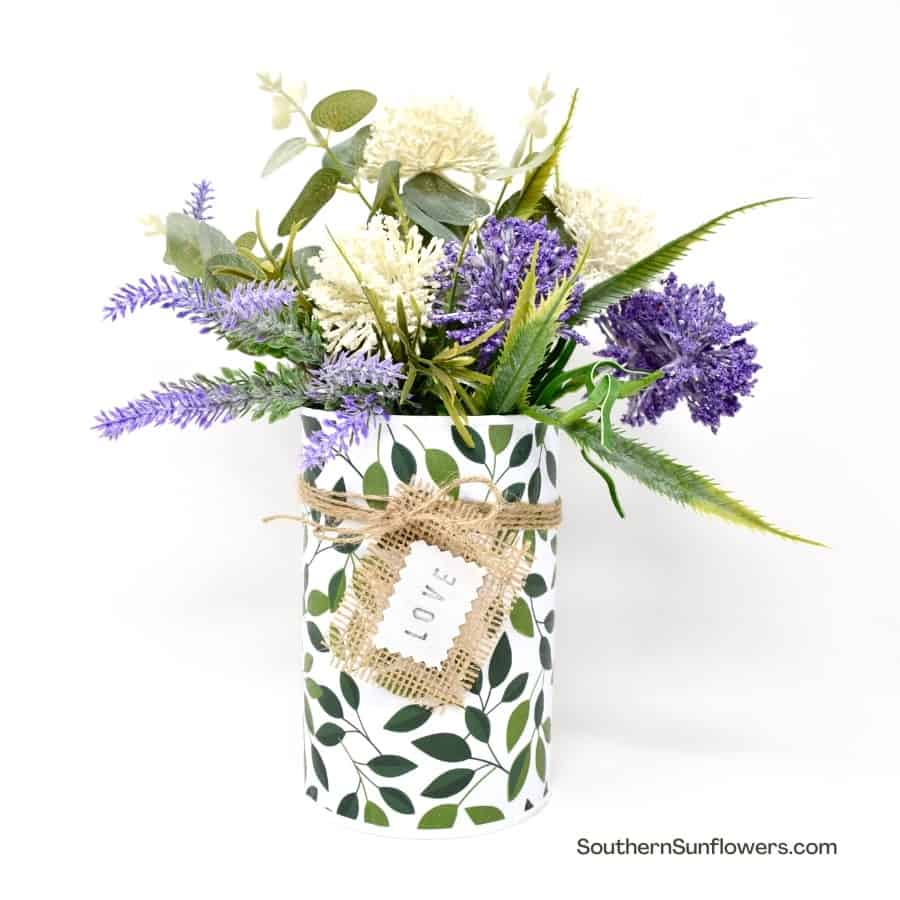 tin can decorated with paper and a love tag