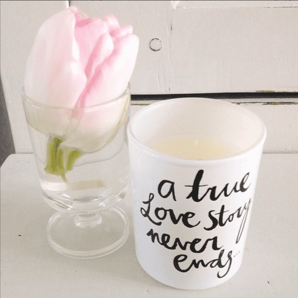 one pink tulip in a drinking glass