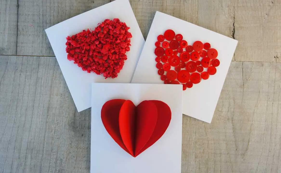 three white cards with red hearts in 3D paper craft